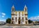 Carmo Church (Igreja do Carmo ) in Faro, Portugal with its famous chapel of bones in warm sunlight - frontal perspective, landscape orientation.