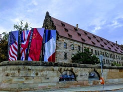 Photo of scenic summer view of the German traditional medieval half-timbered Old Town architecture and bridge over Pegnitz river in Nuremberg, Germany.