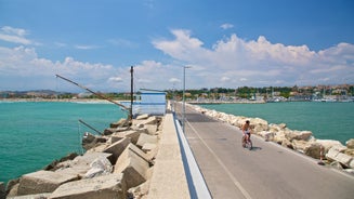 Photo of beach chairs, on a sandy, shoreline, in Giulianova, Italy.