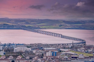 Photo of aerial view of Aberdeen as River Dee flows in a curve to the North Sea showing Duthie Park with bridge and traffic from south.