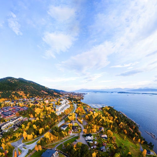 photo of view of Molde, Norway. Aerial view of residential area in Molde, Norway in the evening. Beautiful fjord with mountains in autumn