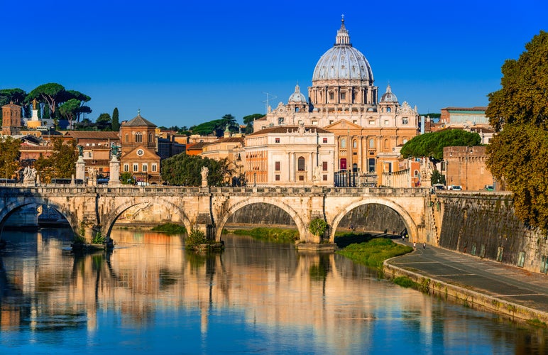  Vatican dome of San Pietro and Sant Angelo Bridge, over Tiber river in Rome, Italy.