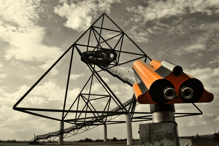 photo of view of the Tetraeder in Bottrop behind a paid binoculars.