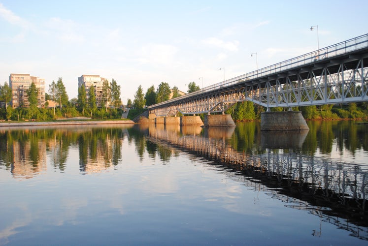 photo of view of The park bridge, "Parkbron", in Skellefteå city center during summer. The south part of the city is reflecting the in river, called Skellefteälven