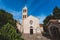 Photo of Rezevici abbey is situated between Budva and Petrovac, Montenegro.Stone belfry and facade of The Serbian Orthodox Rezevici Monastery.