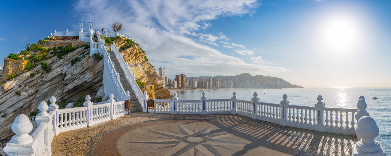 Рanoramic seascape view on beach and skyscrapers from observation deck so-called "Balcon del Mediterraneo" with white balustrade and makeshift compass on the floor. Costa Blanca. Benidorm, Spain.