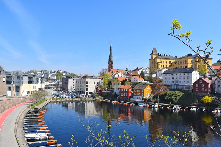 Sea view over the sea. Arendal city, Norway. city view, Arendal, Norway in the spring time on the nice sunny day. boats sit moored at the city habour With colorful house along the sea.