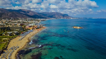 Photo of aerial view of Malia beach and small island with Church of Transfiguration, Heraklion, Crete, Greece.