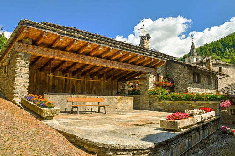 View of an old stone washtub in which women of the Alpine village of Verrand washed clothes in the past, Pré-Saint-Didier, Aosta, Aosta Valley, Alps, Italy