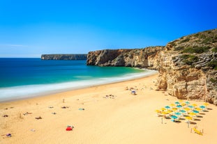 Photo of aerial view of beautiful lighthouse located on high cliffs of Saint Vincent cape in Sagres, Algarve, Portugal.