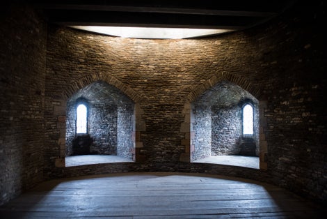 Photo of pair of windows in an empty room of a medieval castle Caerphilly, Wales.
