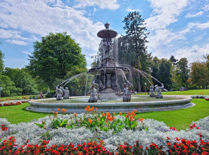 Photo of beautiful fountain in the city park Stadtpark, a green island in the middle of the city center of Graz, Austria.