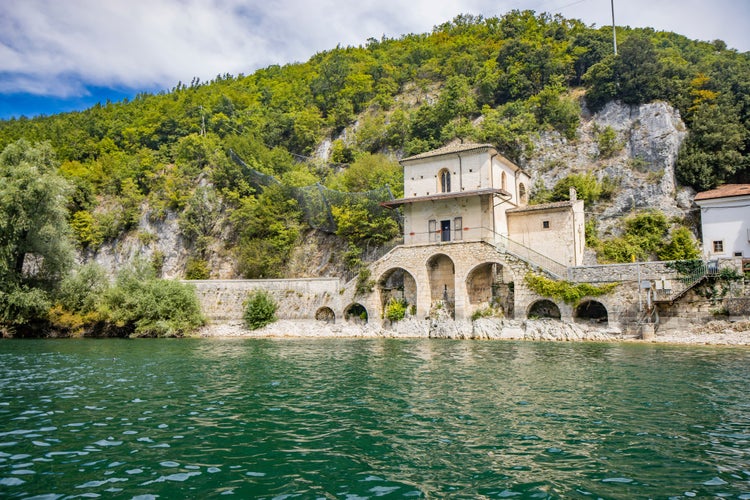 The enchanting Lake Scanno, in Abruzzo, in the province of L'Aquila, located between the Marsican Mountains. The small Church of Santa Maria dell'Annunziata overlooks the waters of the lake.