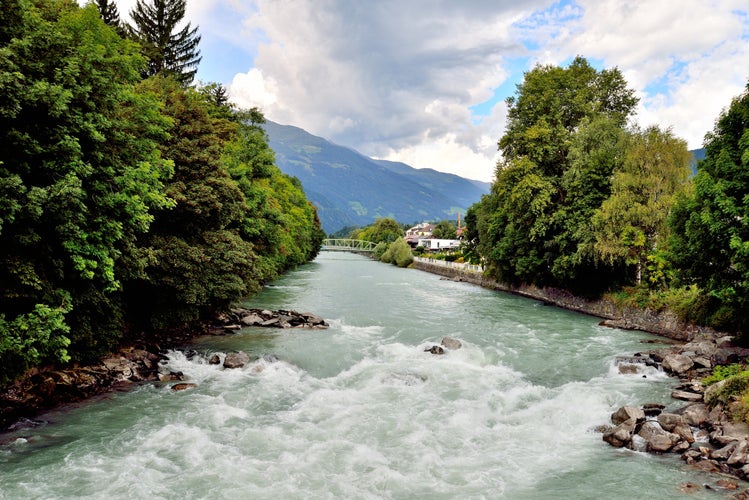 PHOTO OF VIEW OF Swirling river and trees in Lienz, Austria.