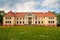 Durbe manor house near Tukums, Latvia with dandelion field in front