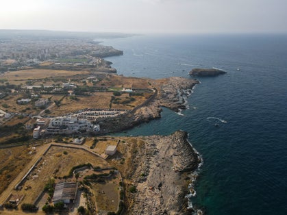 photo of  view of Aerial view of Cala Port'Alga near Torre Incina and Isola dell'Eremita in Polignano a Mare, in Puglia. Drone view of cliffs, coastline in Puglia and small island, near Monopoli, province of Bari.,Polignano a Mare Italy.