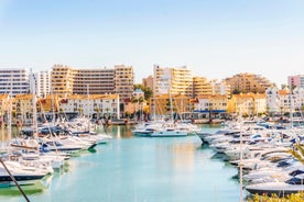 photo of an aerial view of wide sandy beach in touristic resorts of Quarteira and Vilamoura, Algarve, Portugal.