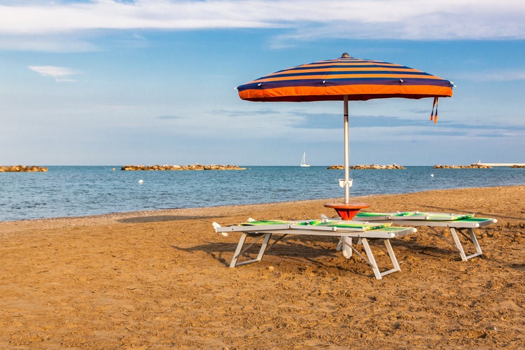 Summer beach landscape with umbrella and beach chairs