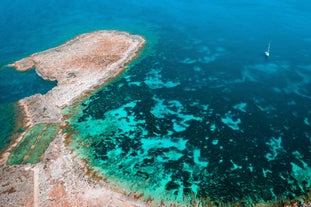 Photo of panoramic aerial view of St. Paul bay with acropolis of Lindos in background ,Rhodes, Greece.