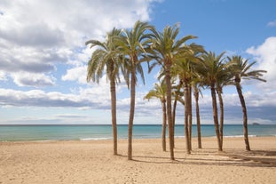 Photo of aerial panoramic view coastline and La Vila Joiosa Villajoyosa touristic resort townscape, sandy beach and Mediterranean seascape, Costa Blanca, Spain.