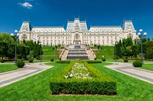 Photo of Water fountain in central square in Iasi town, Cultural Palace in background, Moldavia, Romania.