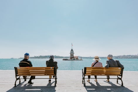  During the coronavirus and curfew Seniors sitting in the Maiden's Tower. elderly people in the risk group sit on the bench according to social distance
