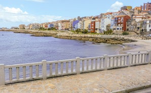 Photo of the well-preserved village of Combarro in Ponteveda, Spain, famous for its stone cruceiros (calvaries) and horreos (raised granaries).