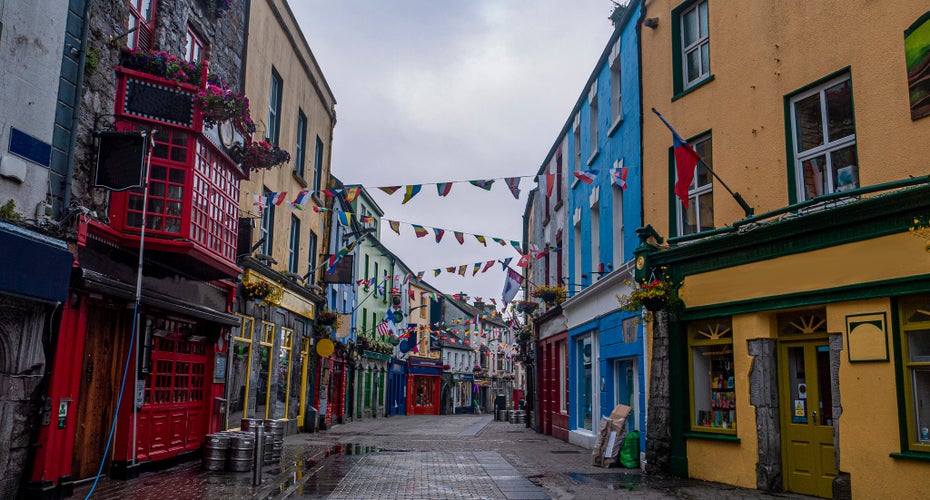 photo  of view of View of the main high street in Galway City with the brightly painted buildings and cobblestone streets on a cloudy day.