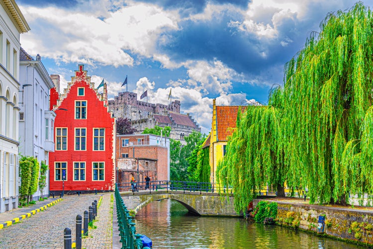 Ghent cityscape, embankment promenade of Lieve water canal, old brick buildings, Ghent historical city centre Prinsenhof Princes Court, Castle of the Counts in Gent old town, Flemish Region, Belgium