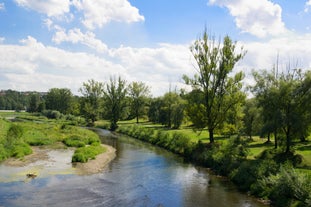 Photo of Lednice Chateau with beautiful gardens and parks on a sunny summer day, Czech Republic.