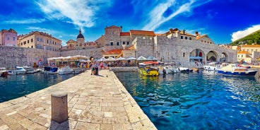 Photo of panorama and landscape of Makarska resort and its harbour with boats and blue sea water, Croatia.