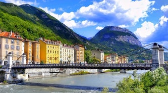 Photo of morning cityscape view with mountains, river and bridge in Grenoble city on the south-east of France.