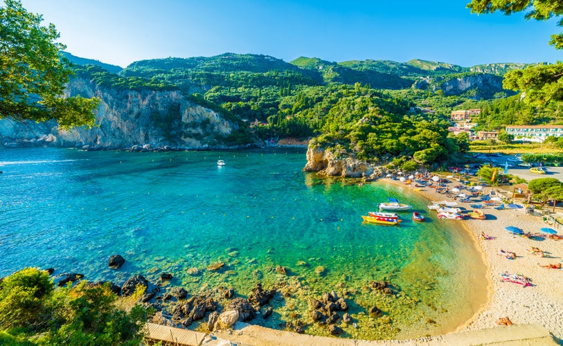 Photo of beautiful beach and boat in Paleokastritsa, Corfu island, Greece.