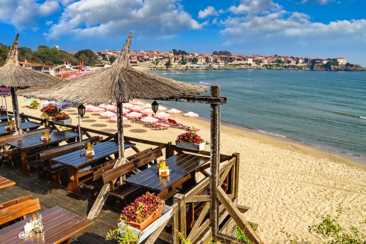 Seaside landscape - view of the cafe and the sandy beach with umbrellas and sun loungers in the town of Sozopol on the Black Sea coast in Bulgaria