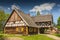 Replica of early 20th century hut with arcade extension, partly half-timbered wall and thatched roof from Masuria region, The Folk Architecture Museum and Ethnographic Park in Olsztynek, Poland.