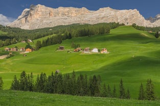 photo of Autumn morning panoramic shot on Stern-La Villa from San Cassiano, Piz la Ila, Gruppo Sella, Sassongher, Piza de Gherdenacia, Peitlerkofel in Italy.