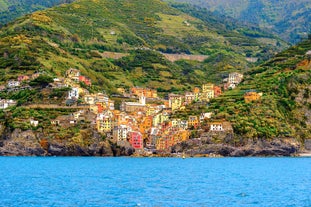 Photo of Riomaggiore with colorful houses along the coastline, one of the five famous coastal village in the Cinque Terre National Park, Liguria, Italy.