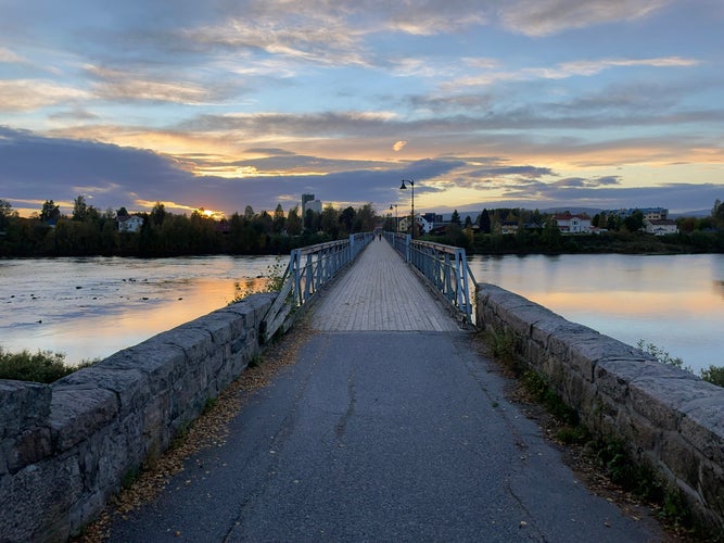 photo of view ofBeautiful sunset over old bridge in Elverum city in Norway.