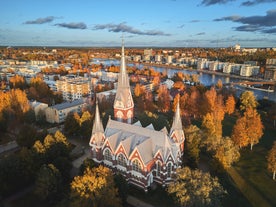 Aerial view of the Tampere city at sunset. Tampella building. View over Tammerkoski river in warm sunlight.