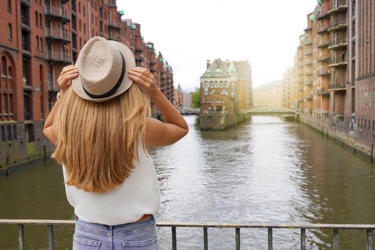 Photo of tourist woman visiting Speicherstadt district in the port of Hamburg.