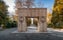 Photo of The Gate of the Kiss (Poarta sarutului) sculpture made by Constantin Brancusi in Targu Jiu, Romania - amazing autumn wide angle view .