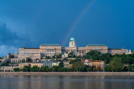 photo of The Hungarian National Gallery in the former Royal palace of the Hungarian kingdom with rainbow and the Danube .