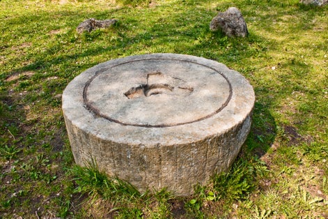 Photo of Ancient millstone in park of boulders, Minsk, Belarus.