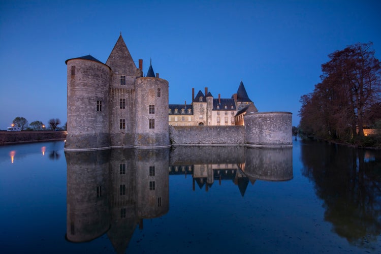 Photo of Sully Sur Loire, France - April 13, 2019: Famous medieval castle Sully sur Loire at sunset, Loire valley, France. The chateau of Sully sur Loire dates from the end of the 14th century.