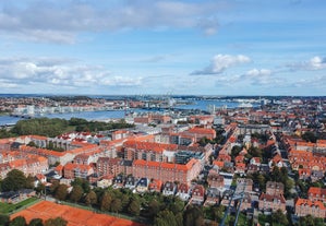 Scenic summer view of Nyhavn pier with color buildings, ships, yachts and other boats in the Old Town of Copenhagen, Denmark