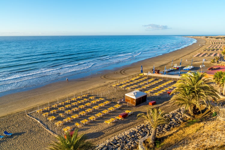 Photo of aerial view of the beach of Playa del Ingles on Gran Canaria in Spain at sunrise.