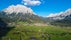 Photo of a view of the Alps from the Ehrwald, a town on the border of Germany and Austria with picturesque meadows surrounded by towering mountain ranges, including the Zugspitze.