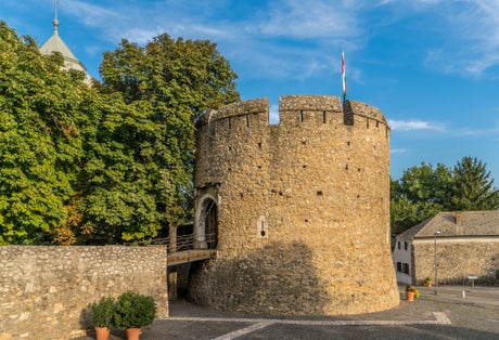 Summer view of the barbakan of Pecs, medieval circular defensive gate tower with loopholes, draw ridge, moat protecting the town from Turkish invasion
