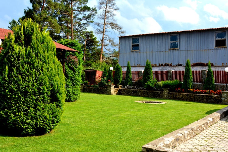 photo of view of Typical house, garden and courtyard in the city Sacele, Transylvania, Romania.