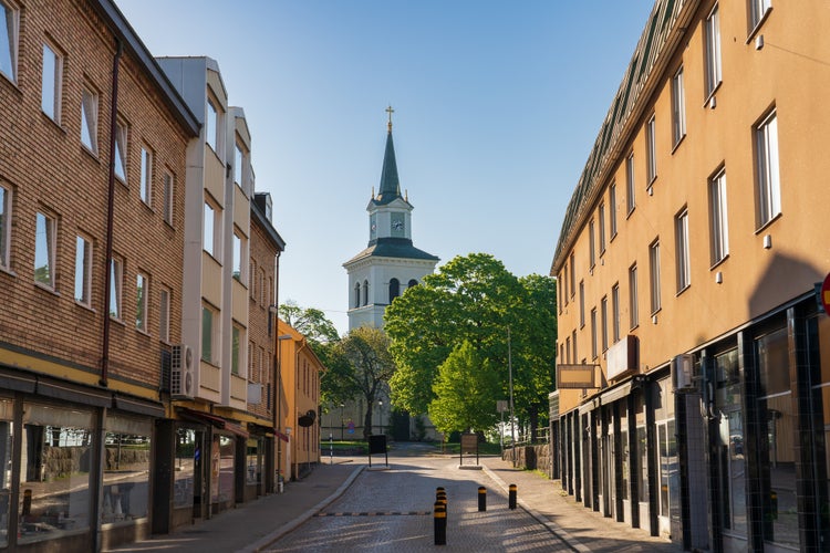 photo of a street in Vimmerby with Tower of Vimmerby Kyrka evangelical church Vimmerby, Sweden.